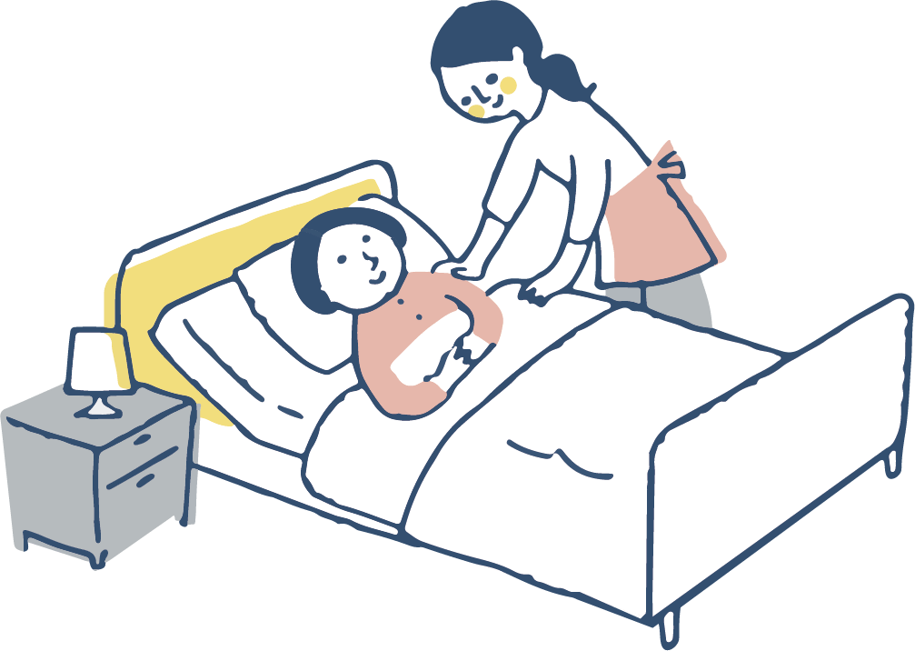 ベッドで休む利用者さんと、見守るスタッフ
